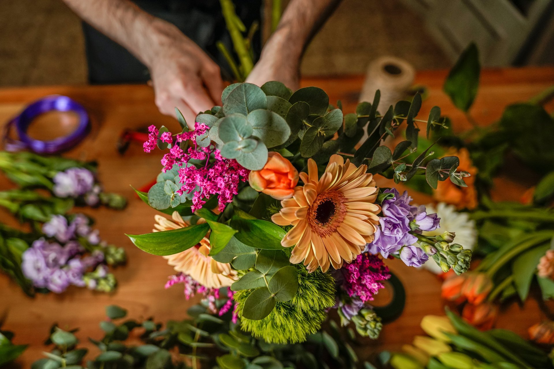 Florist creating a vibrant bouquet